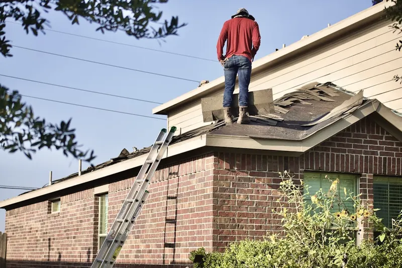 Professional roofer working on a residential roof in Eaglebrook